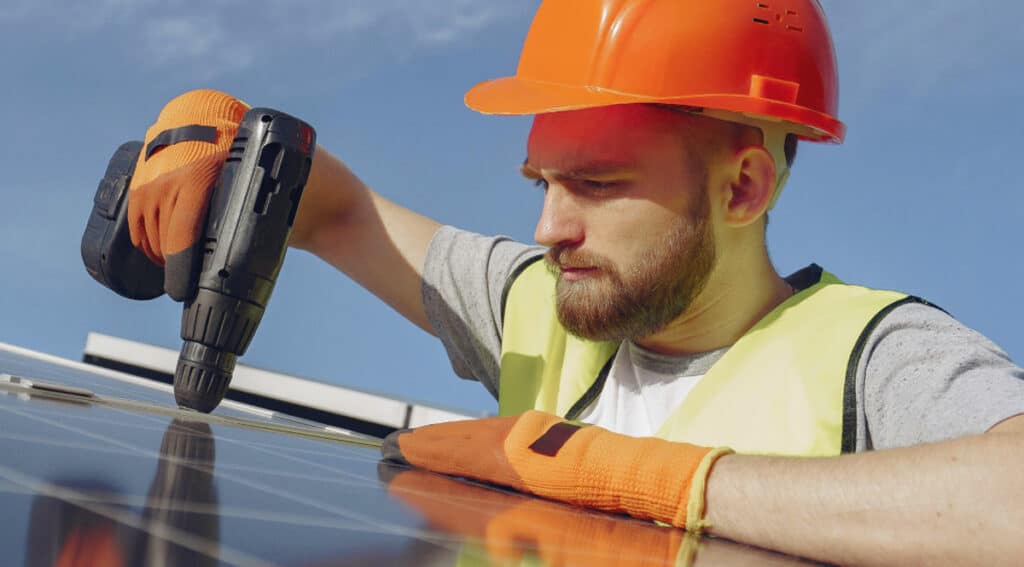 Construction worker mounting solar panels