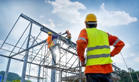 framed building with workers